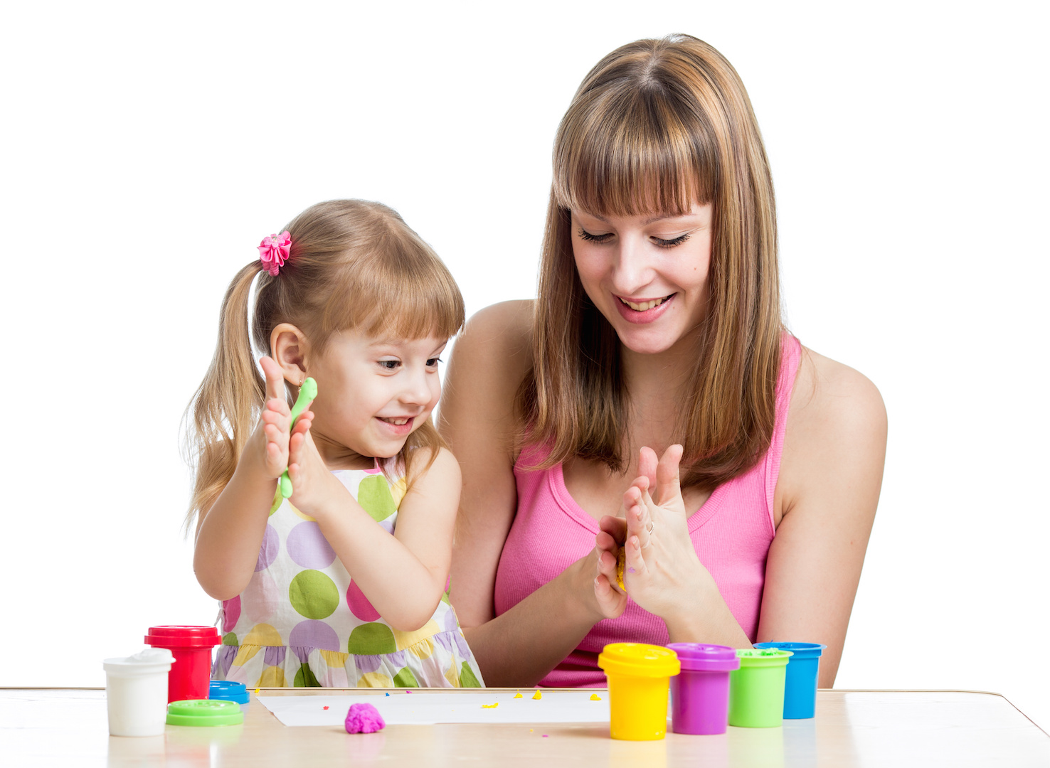 kid girl and mother playing colorful clay toy.